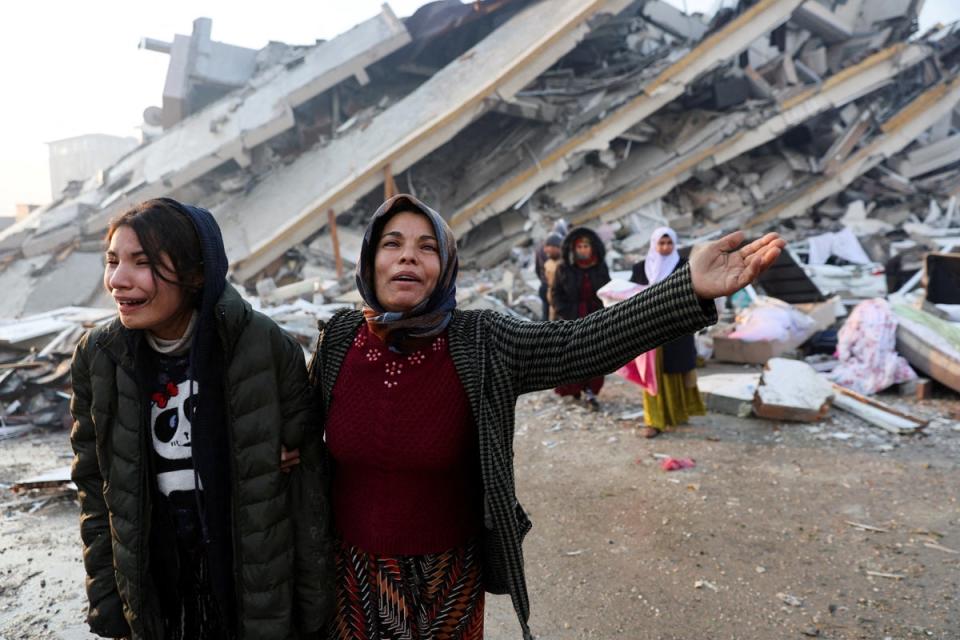 Women react near rubble following an earthquake in Hatay, Turkey, (REUTERS)