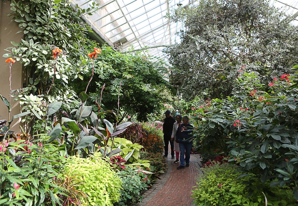 Visitors pass through the East Conservatory of Longwood Gardens in Kennett Square, Pa.