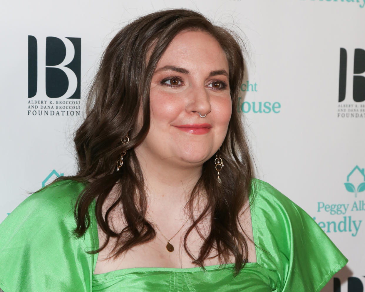 Lena Dunham hit the beach in a sunny yellow swimsuit. (Photo: Paul Archuleta/FilmMagic)