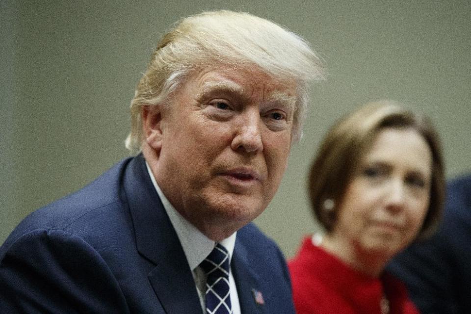 Cape Cod Five Cents Savings Bank CEO Dorothy Savarese listens at right as President Donald Trump meets with leaders from small community banks, Thursday, March 9, 2017, in the Roosevelt Room of the White House in Washington. (AP Photo/Evan Vucci)