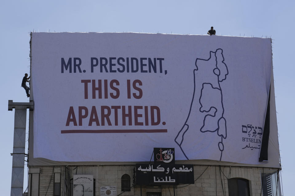 A billboard saying "Mr. President, this is apartheid" is posted by an Israeli human rights group in the West Bank town of Bethlehem ahead of the arrival of President Joe Biden in the region, Wednesday, July 13, 2022. The group B'Tselem put up the billboards in Ramallah, the seat of the internationally recognized Palestinian Authority, and in Bethlehem, where Biden is to meet Palestinian President Mahmoud Abbas on Friday. (AP Photo/Mahmoud Illean)