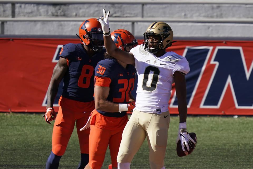 Purdue wide receiver Milton Wright, right, celebrates his touchdown reception as Illinois defensive back Sydney Brown (30) and Nate Hobbs watch during the first half of an NCAA college football game Saturday, Oct. 31, 2020, in Champaign, Ill. (AP Photo/Charles Rex Arbogast)