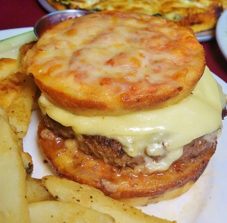 ‘The Ando’ burger is a ½ pound certified angus beef burger served between two mini-cheese pizzas.