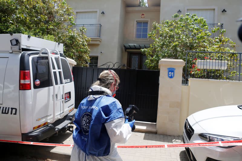 An Israeli police forensic expert holds a camera as she prepares to enter China's ambassador to Israel, Du Wei's house in Herzliya, near Tel Aviv, Israel