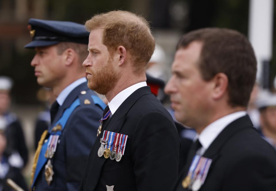 The Prince of Wales, Duke of Sussex and Prince Phillips walk behind the late Queen's coffin in Westminster, 2022