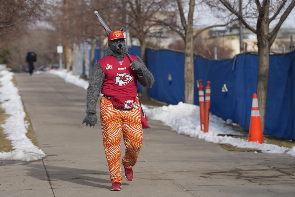 A Kansas City Chiefs fan, Chiefsaholic, walks toward Empower Field at Mile High before an NFL football game between the Denver Broncos and the Chiefs Saturday, Jan. 8, 2022, in Denver. (AP Photo/David Zalubowski)