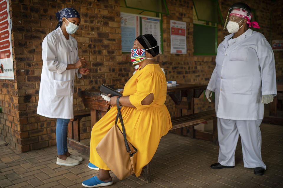 A South African woman is briefed before taking a COVID-19 test at the Ndlovu clinic in Groblersdal , 200 kms north-east of Johannesburg Thursday Feb. 11, 2021. African countries without the coronavirus variant dominant in South Africa should go ahead and use the AstraZeneca COVID-19 vaccine, the Africa Centers for Disease Control and Prevention said Thursday, while the World Health Organization suggested the vaccine even for countries with the variant circulating widely.(AP Photo/Jerome Delay)