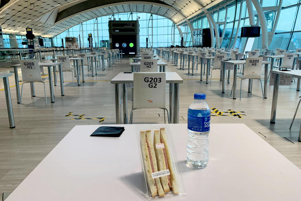 Passengers arriving at Hong Kong International Airport are assigned desks at an unused gate while they wait for their Covid test results. (Jennifer Jett / NBC News)