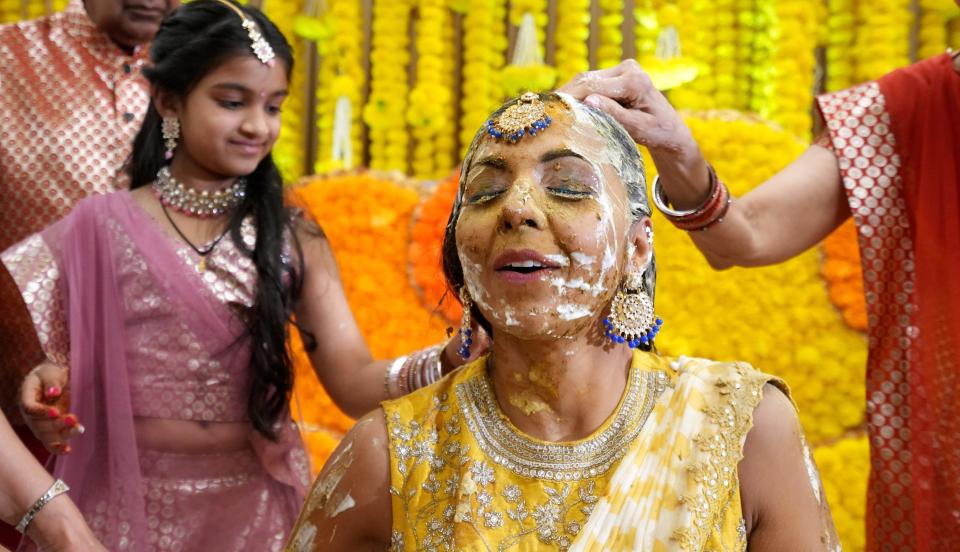 During the haldi ceremony, Rupal Ramesh Shah gets tumeric, yogurt and sandalwood placed on her body by close family members and friends prior to her wedding. It was one of the traditional Indian components of her wedding.