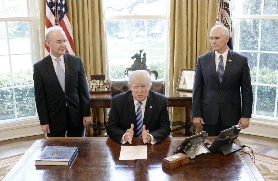 U.S. President Donald Trump reacts with HHS Secretary Tom Price (L) and Vice President Mike Pence (R) after Republicans abruptly pulled their health care bill from the House floor. (Photo by Olivier Douliery-Pool/Getty Images)