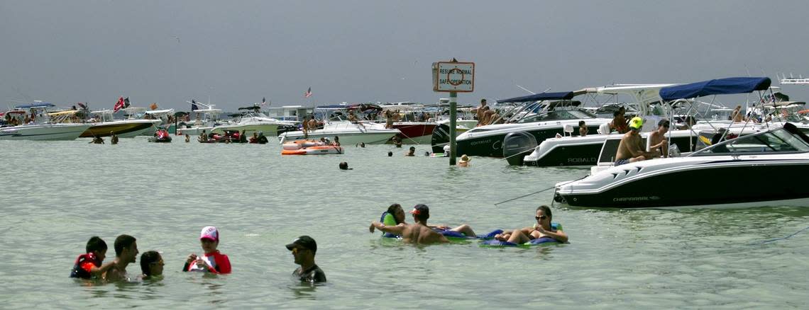 Swimmers enjoy the water on the Nixon Beach sandbar off of Key Biscayne on Sunday September 6, 2015.