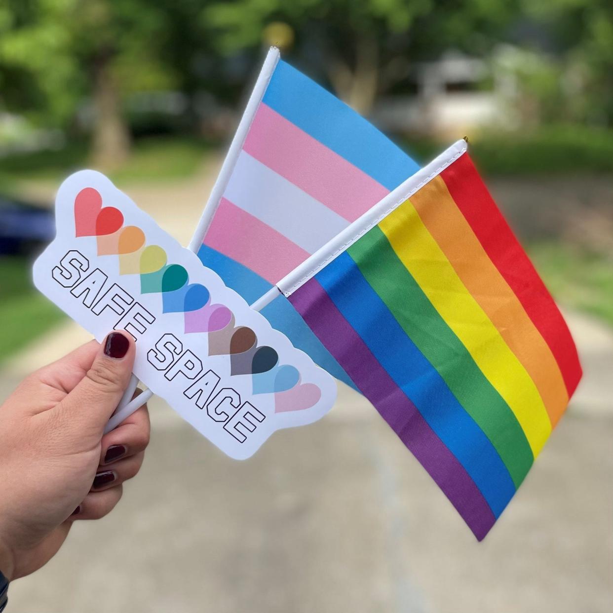 An image of Pride flags, buttons and Safe Space stickers provided by PFLAG, an organization dedicated to supporting, educating, and advocating for LGBTQ+ people.