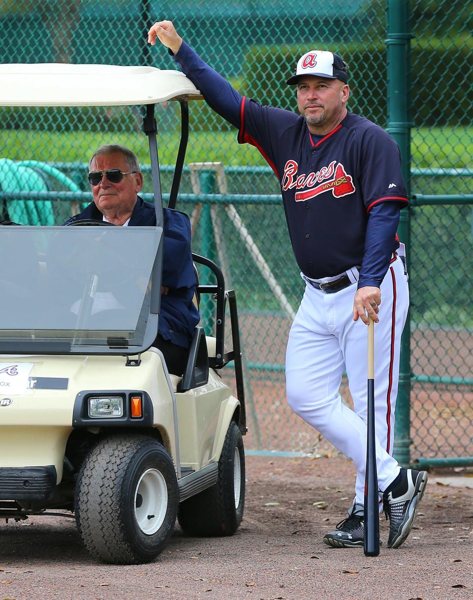 Atlanta Braves manager Fredi Gonzalez and former manager Bobby Cox, left, watch over practice at baseball spring training Thursday, Feb 26, 2015, in Kissimmee, Fla. (AP Photo/Atlanta Journal-Constitution, Curtis Compton)