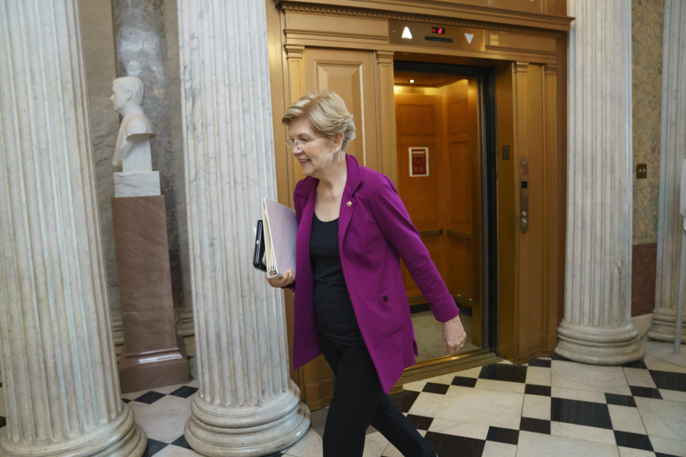 Sen. Elizabeth Warren, D-Mass., rushes to the Senate chamber for votes, at the Capitol in Washington, Thursday, June 10, 2021. Sen. Warren is working with a bipartisan group of 10 senators negotiating an infrastructure deal with President Joe Biden. (AP Photo/J. Scott Applewhite)