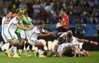 Germany's Mario Goetze (C) celebrates with teammates after winning their 2014 World Cup final against Argentina at the Maracana stadium in Rio de Janeiro July 13, 2014. REUTERS/Dylan Martinez