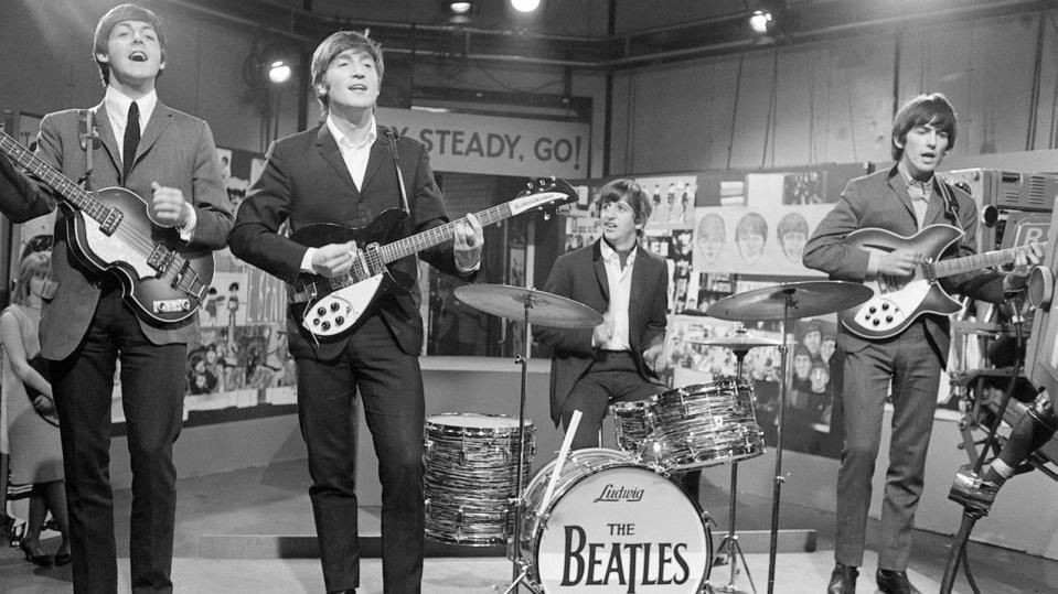 PHOTO: The Beatles at Television House, Kingsway, for an appearance on the television Show 'Ready, Steady, Go' Left to right: Paul McCartney, John Lennon, Ringo Starr and George Harrison pictured playing on stage. March 20, 1964. (Mirrorpix via Getty Images)