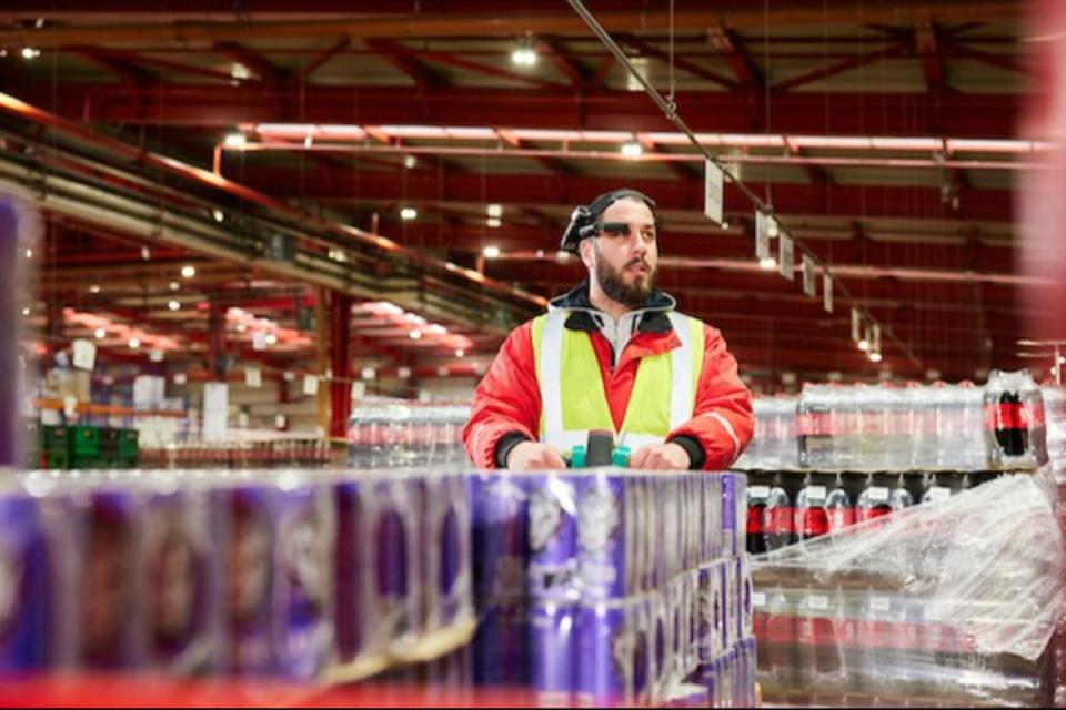 A Coca-Cola HBC worker wearing augmented reality smart glasses (coca cola hbc press image)