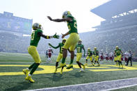 Oregon running back Travis Dye (26) celebrates his touchdown against Fresno State during the first quarter of an NCAA college football game, Saturday, Sept. 4, 2021, in Eugene, Ore. Smoke from wildfires is also seen in the stadium. (AP Photo/Andy Nelson)
