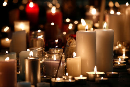 Candles burn in tribute to the victims of the deadly shooting in Strasbourg, France, December 13, 2018. REUTERS/Christian Hartmann