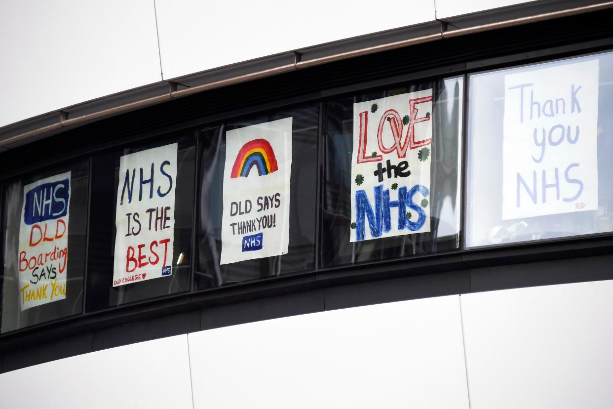 Messages in support of the NHS are seen at the windows of the DDL College, in front of St Thomas' Hospital, one of the many hospitals dealing with Coronavirus patients in London, Wednesday, April 1, 2020.