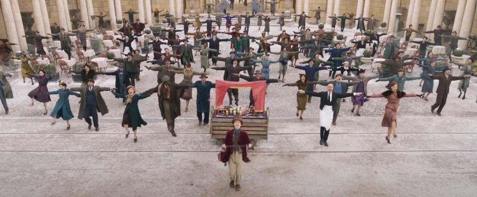 Timothée Chalamet's Willy Wonka leads a group dance in "Wonka."