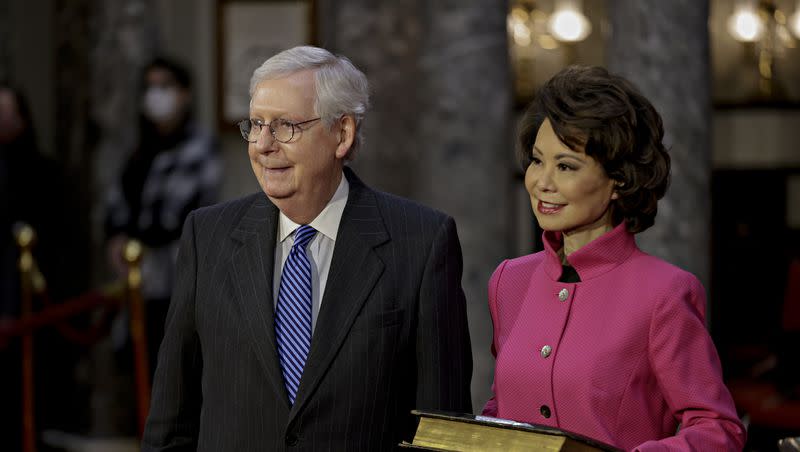 Sen. Mitch McConnell, R-Ky., and his wife Transportation Secretary Elaine Chao, wait for McConnell to be sworn in during a reenactment ceremony in the Old Senate Chamber at the Capitol in Washington, Sunday, Jan. 3, 2021. The Hatch Foundation will honor McConnell and Chao with the Titan of Public Service Award. 