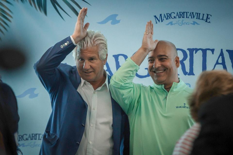 Margaritaville CEO John Cohlan, left, and Oneil Khosa, CEO of Bahamas Paradise Cruise Line, pose for photos during a press event at the Port of Palm Beach on Wednesday. The Margaritaville Paradise, the former Grand Classica, will launch service on April 30 after what is expected to be an extensive refit at Grand Bahama.