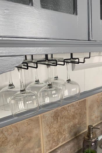 a reviewer's wine glass rack under kitchen cabinets