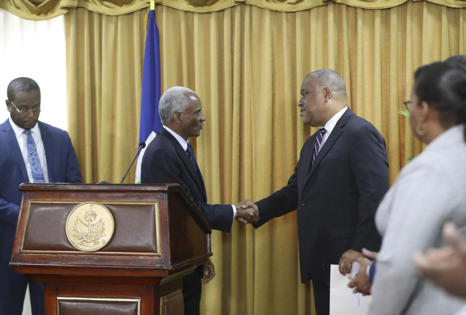 President of the council Edgard Leblanc Fils greets Garry Conille, right, after his swearing-in ceremony as prime minister in Port-au-Prince, Haiti, Monday, June 3, 2024. (AP Photo/Odelyn Joseph)