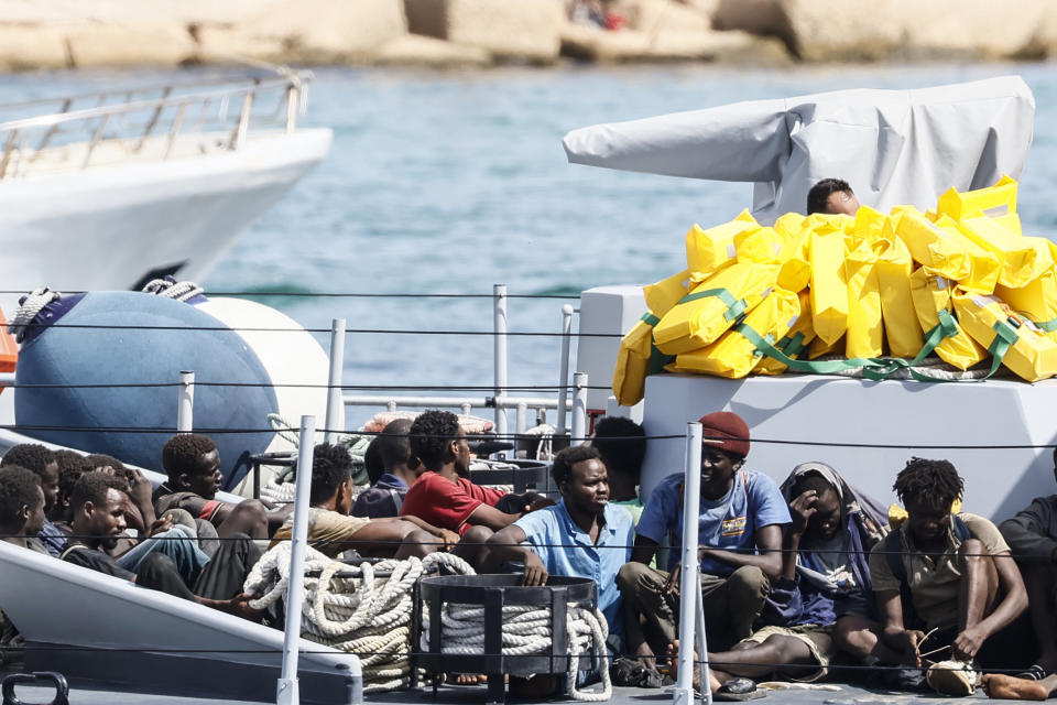 Rescued migrants sit in a boat of the Italian Finance Police before disembarking at the port of the Sicilian island of Lampedusa, southern Italy, Monday, Sept. 18, 2023. The Italian Cabinet met Monday to adopt new measures to crack down on migration after the southern island of Lampedusa was again overwhelmed by a wave of arrivals from Tunisia and the migration issue again took center stage in Europe with talk of a naval blockade. (Cecilia Fabiano/LaPresse via AP)