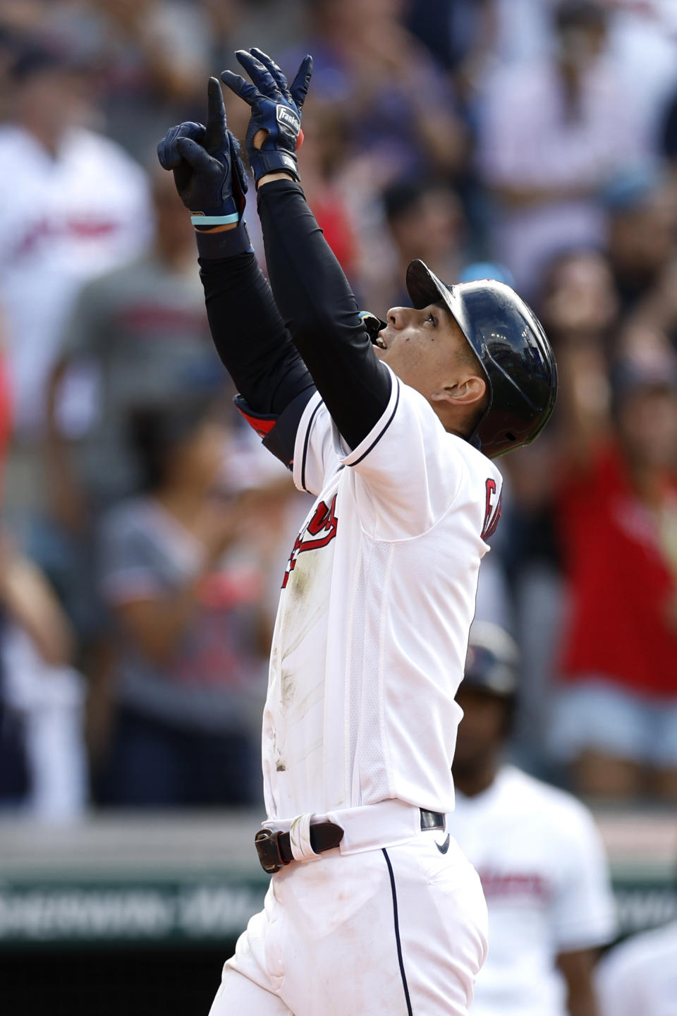 Cleveland Guardians' Andres Gimenez celebrates after hitting a three-run home run off Detroit Tigers relief pitcher Andrew Chafin during the seventh inning in the first baseball game of a doubleheader Monday, Aug. 15, 2022, in Cleveland. (AP Photo/Ron Schwane)