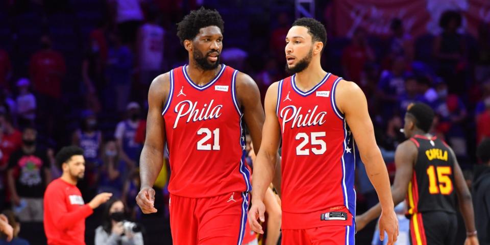 Joel Embiid and Ben Simmons talk to each other while walking off the court during a Sixers game in 2022.