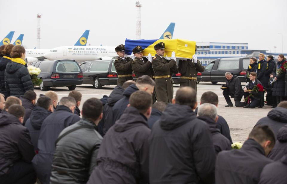 In this photo provided by the Ukrainian Presidential Press Office, honor guard carry a coffin of the one of the eleven Ukrainian victims of the Ukrainian 737-800 plane that crashed on the outskirts of Tehran, at Borispil international airport outside Kyiv, Ukraine, Sunday, Jan. 19, 2020. An Ukrainian passenger jet carrying 176 people has crashed just minutes after taking off from the Iranian capital's main airport on Jan. 8, 2020. (Ukrainian Presidential Press Office via AP)