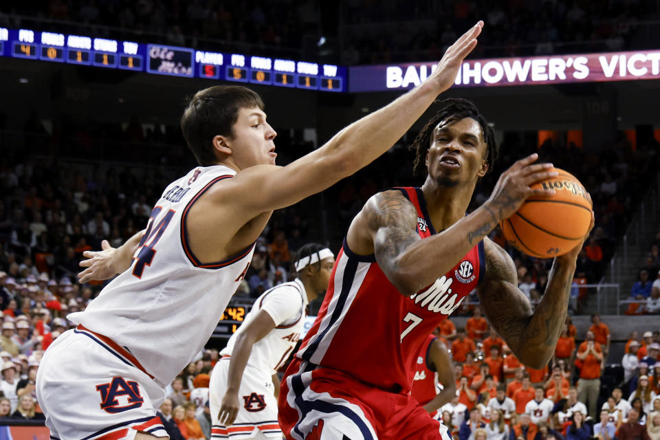 Mississippi guard Allen Flanigan (7) tries to get around Auburn guard Lior Berman (24) during the first half of an NCAA college basketball game Saturday, Jan. 20, 2024, in Auburn, Ala. (AP Photo/Butch Dill)