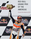 Marc Marquez of Spain holds up the trophy after winning the Grand Prix of the Americas MotoGP motorcycle race, Sunday, April 13, 2014, in Austin, Texas. (AP Photo/Tony Gutierrez)