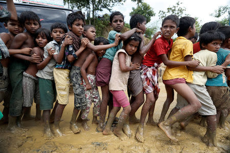 Rohingya refugee children queue for aid in Cox's Bazar, Bangladesh, September 21, 2017. REUTERS/Cathal McNaughton