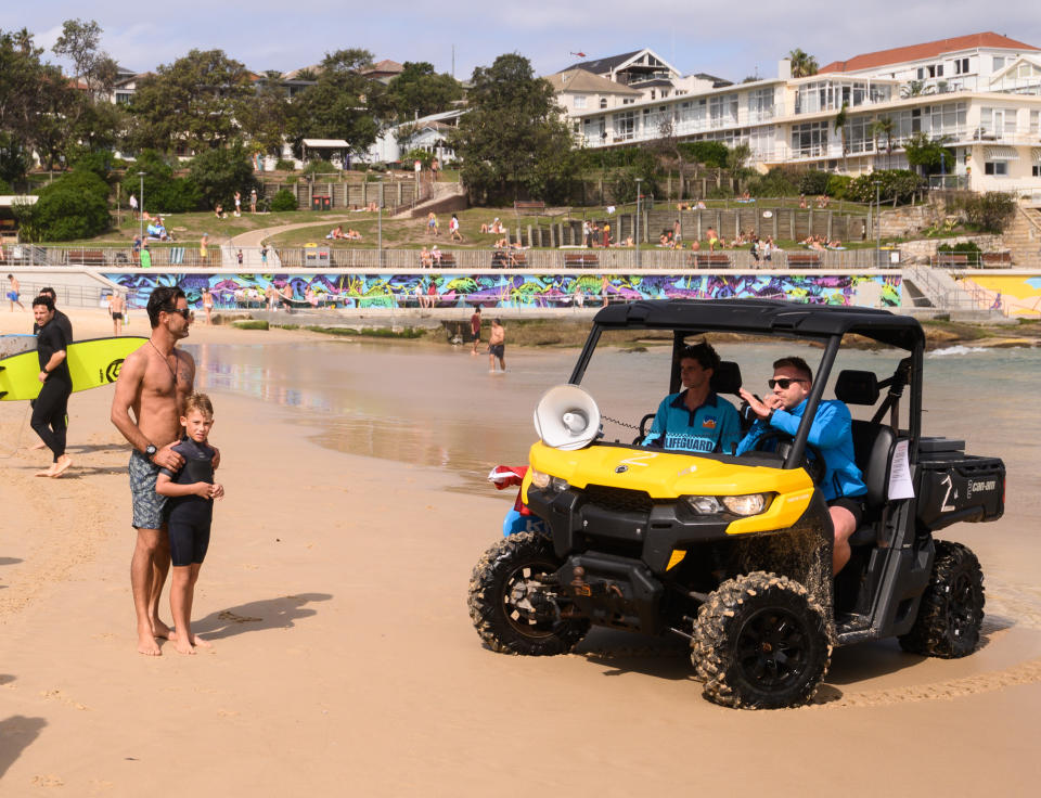 Lifeguards direct beachgoers after the closure of Bondi Beach. Source: AAP