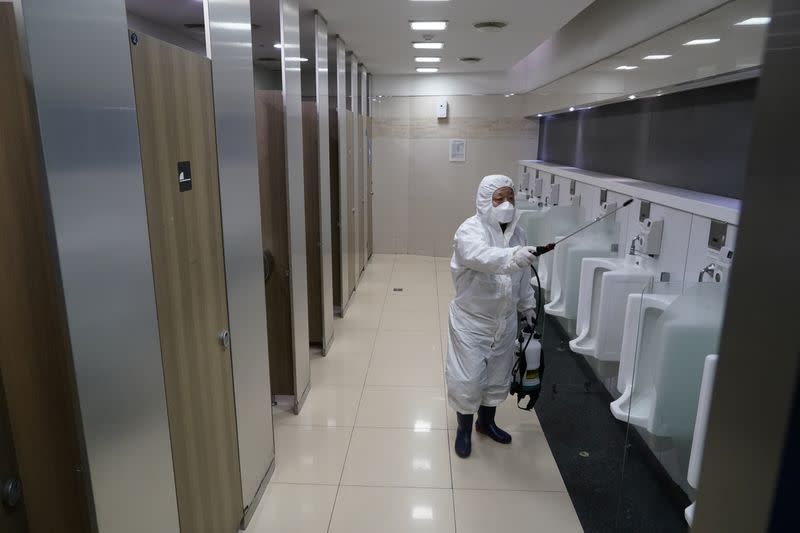 An employee from a disinfection service company sanitizes toilets of Seoul Railway Station in Seoul