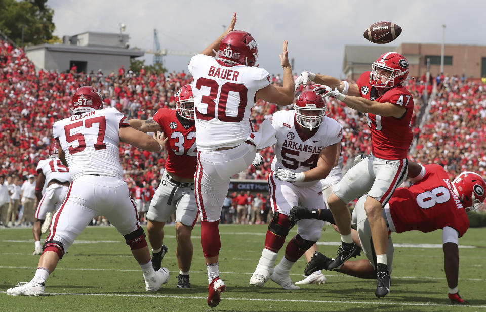 Georgia defensive back Dan Jackson blocks the punt in the endzone by Arkansas kicker Reid Bauer and Georgia recovered for the touchdown during the first quarter of an NCAA college football game on Saturday, Oct. 2, 2021, in Athens. (Curtis Compton/Atlanta Journal-Constitution via AP)