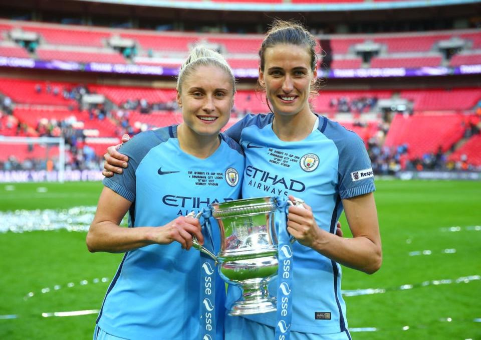 Houghton holds the FA Cup trophy with former Man City and England teammate Jill Scott (Getty)