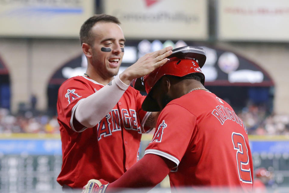 Los Angeles Angels' Zach Neto, left, puts the halo on Luis Rengifo (2) at the dugout after Rengifo's two-run home run against the Houston Astros during the first inning of a baseball game Tuesday, May 21, 2024, in Houston. (AP Photo/Michael Wyke)