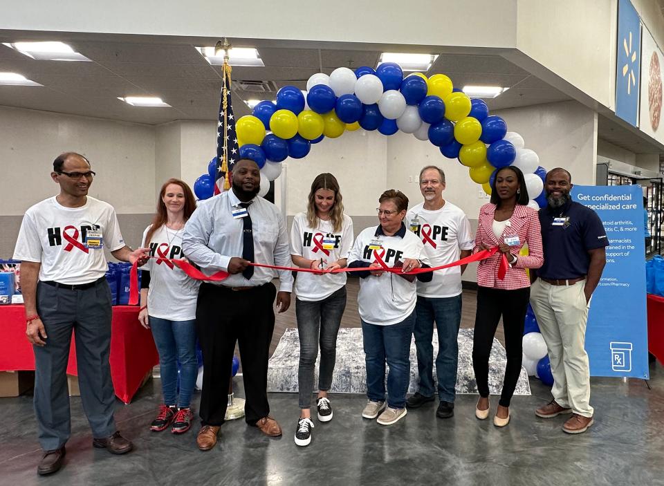 Staff celebrate the opening of a specialty HIV pharmacy at a Walmart in St. Johns County, one of eight opening this week across the Jacksonville area.