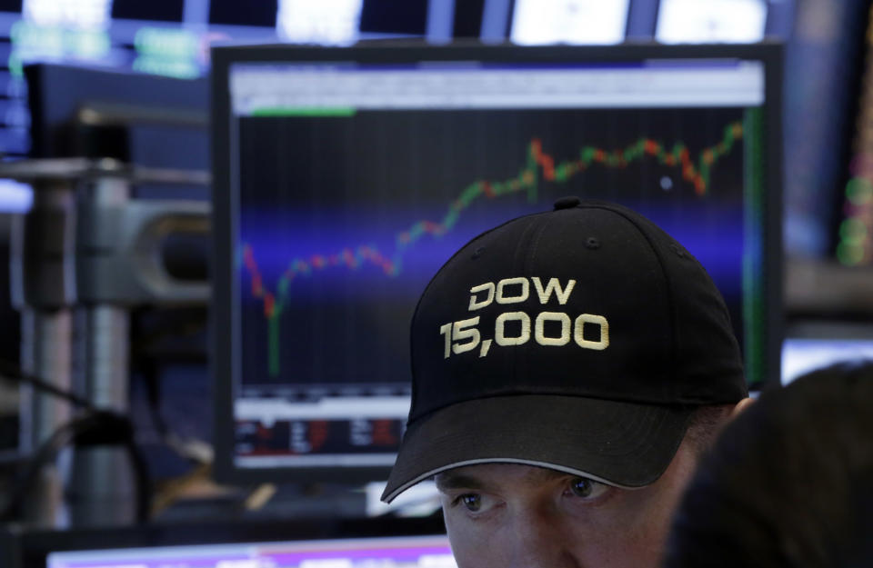 FILE - In this Friday, May 3, 2013, file photo, a specialist wears a "Dow 15,000" hat as he works at his post on the floor of the New York Stock Exchange, as a big gain in the job market is lifting the stock market to a record high. The stock market surged, traders donned party hats, and the wave of buying drove three indexes through major milestones in 2013. (AP Photo/Richard Drew, File)