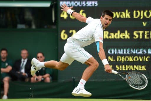 Serbia's Novak Djokovic plays a backhand shot during his third round men's singles match against Czech Republic's Radek Stepanek at the All England Tennis Club in Wimbledon, southwest London. Djokovic eased into the fourth round with a 4-6, 6-2, 6-2, 6-2 win over Stepanek