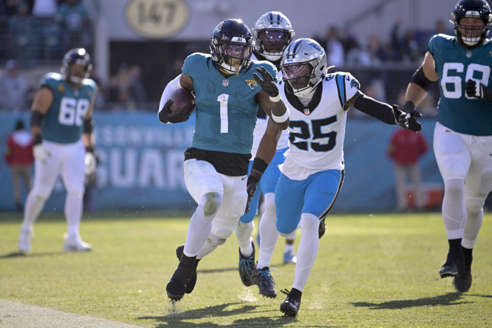 Jacksonville Jaguars running back Travis Etienne Jr. runs for a touchdown against the Carolina Panthers during the second half of an NFL football game Sunday, Dec. 31, 2023, in Jacksonville, Fla. (AP Photo/Phelan M. Ebenhack)