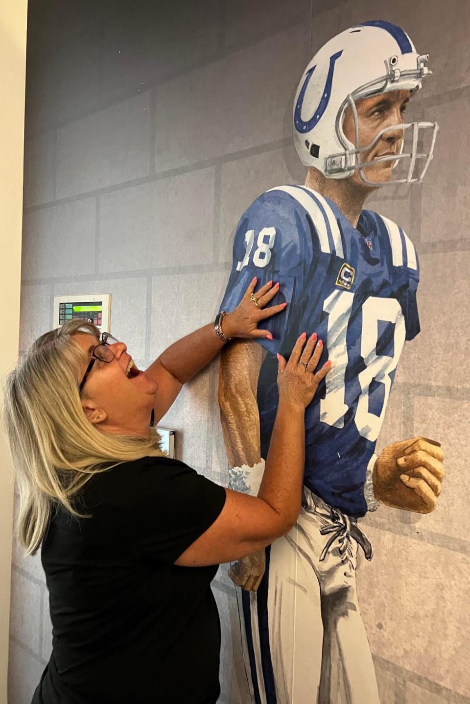 A Peyton Manning fan admires a display at the Pro Football Hall of Fame in Canton last summer.