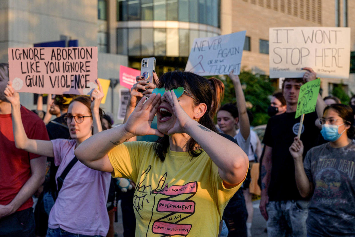 Activists with banners. (Angela Weiss / AFP via Getty Images)