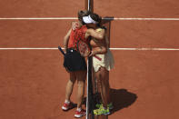 Karolina Muchova of the Czech Republic, left, and Russia's Anastasia Pavlyuchenkova hug each other after their quarter final match of the French Open tennis tournament at the Roland Garros stadium in Paris, Tuesday, June 6, 2023. (AP Photo/Aurelien Morissard)