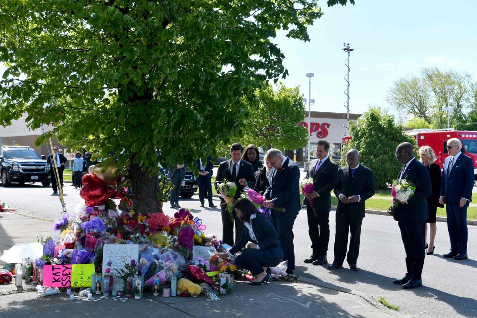 US President Joe Biden and US First Lady Jill Biden look on as New York State Governor Kathy Hochul and US Senate Majority Leader Chuck Schumer read a note at a memorial near a Tops grocery store in Buffalo (AFP via Getty Images)