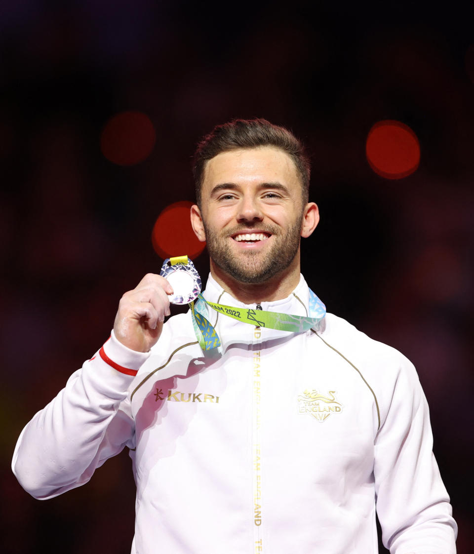 Commonwealth Games - Artistic Gymnastics - Men's Parallel Bars - Medal Ceremony - Arena Birmingham, Birmingham, Britain - August 2, 2022 Silver medallist England's Giarnni Regini-Moran on the podium during the medal ceremony REUTERS/Stoyan Nenov